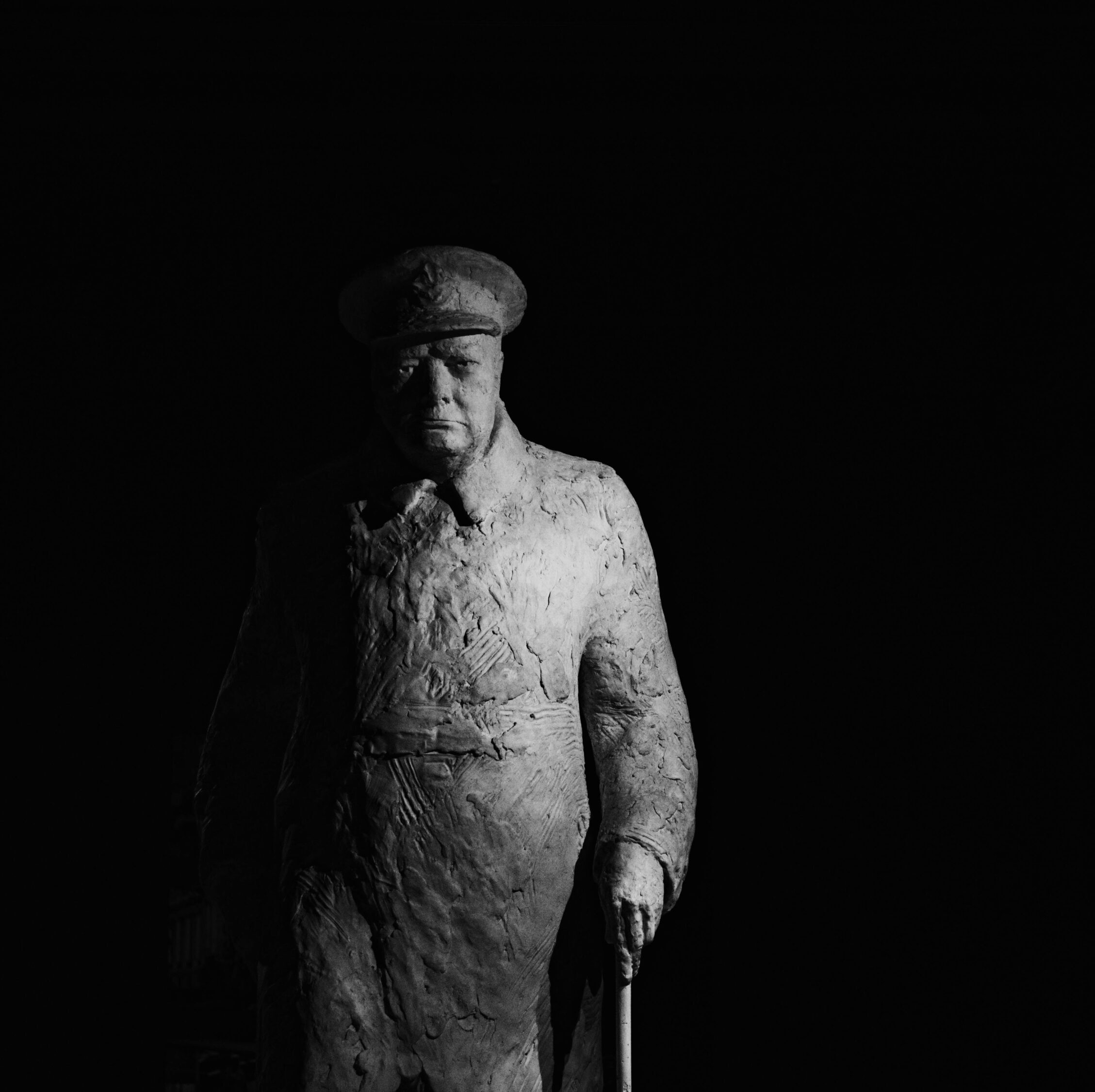 A powerful black and white photograph of a Winston Churchill statue in Paris, France.