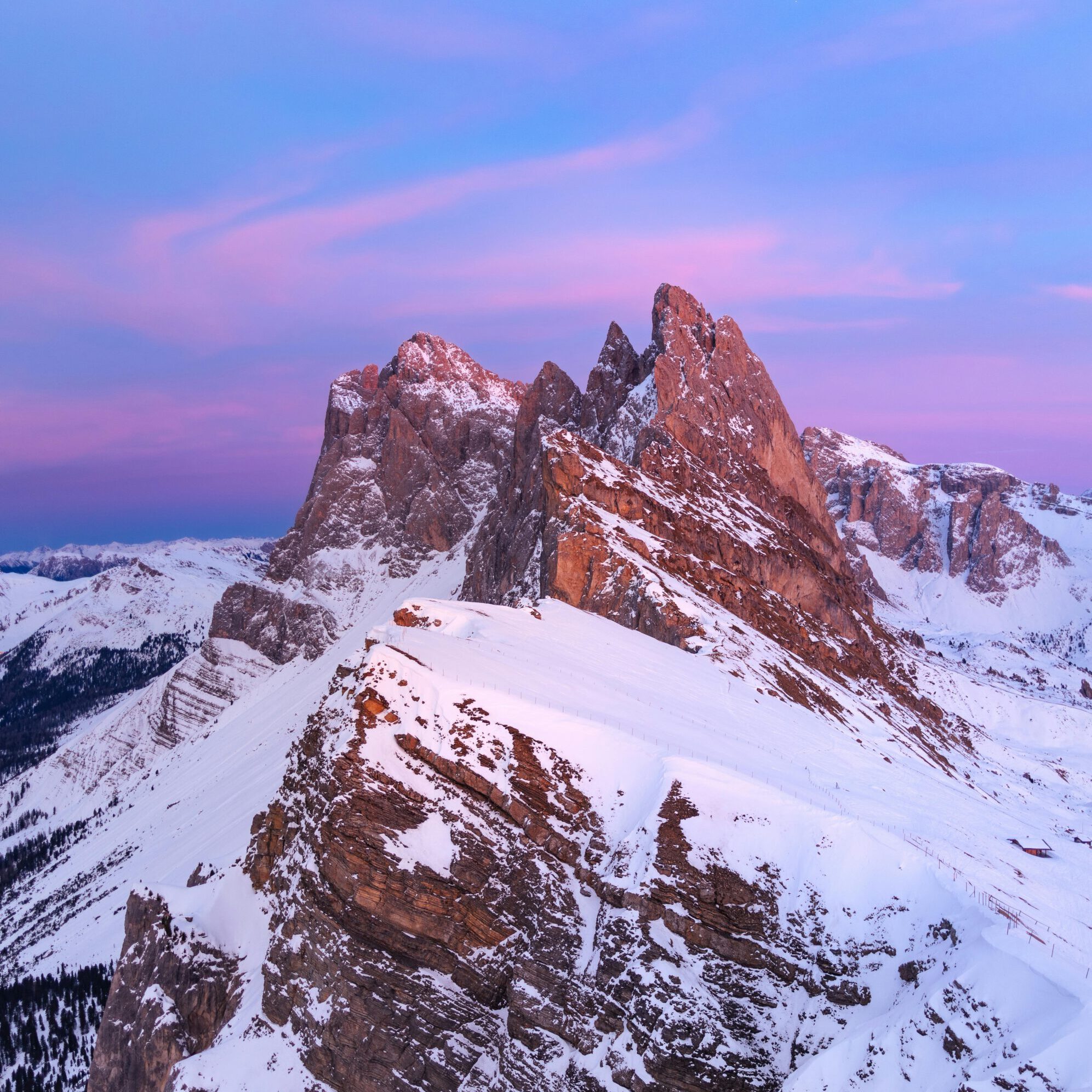 Stunning view of the Seceda peaks during a winter sunset in the Dolomites, Italy.