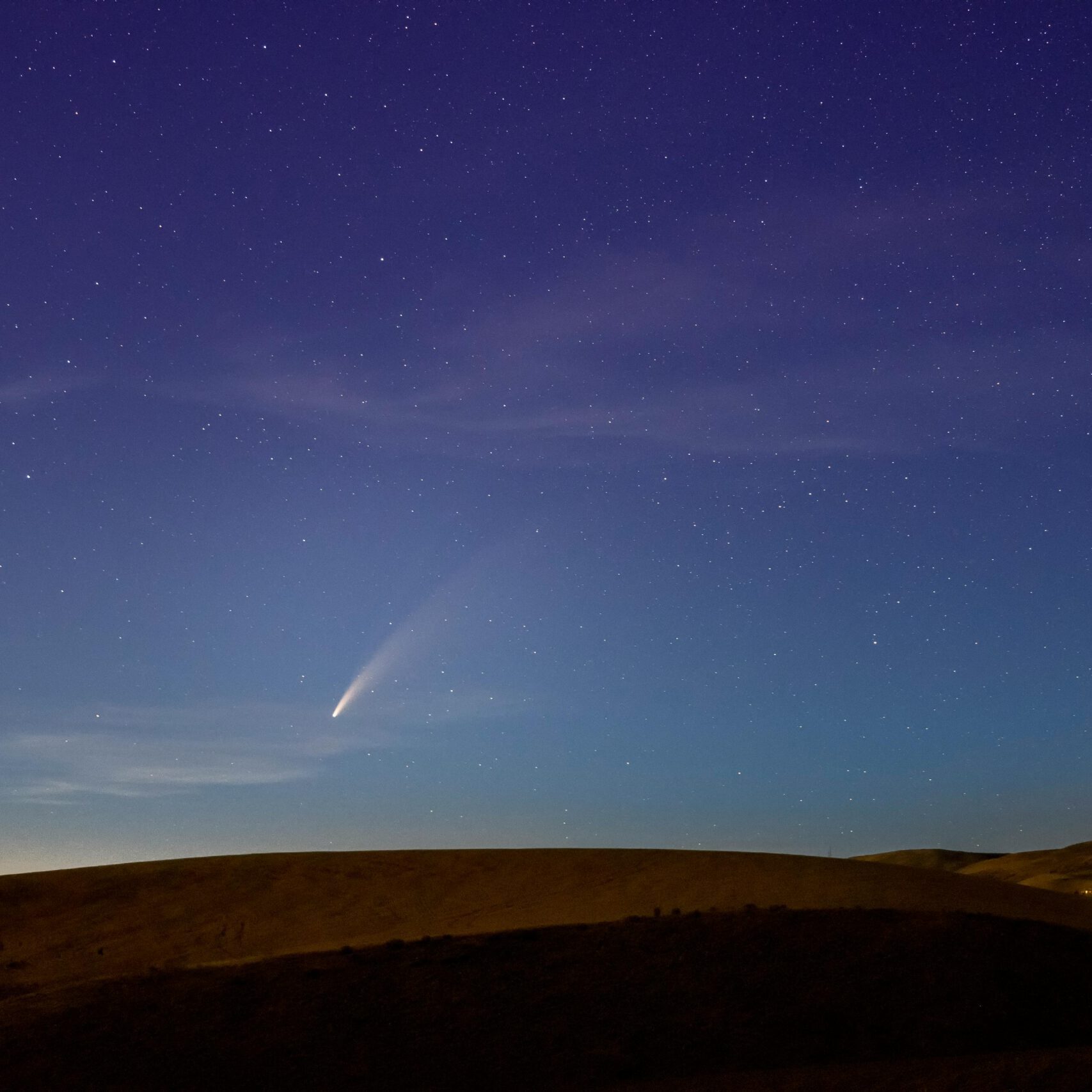 Beautiful night sky with a comet over the hills in Wenatchee, Washington. Perfect astrophotography capture.